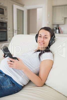 Pregnant woman listening to music with unborn child