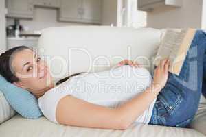 Pregnant woman relaxing in the living room