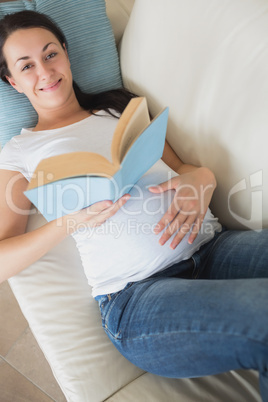 Prospective mother reading a book