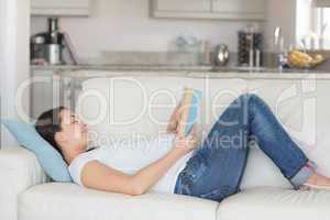 Pregnant woman relaxing on sofa