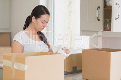 Woman unpacking in kitchen