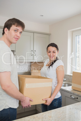 Young couple holding a box