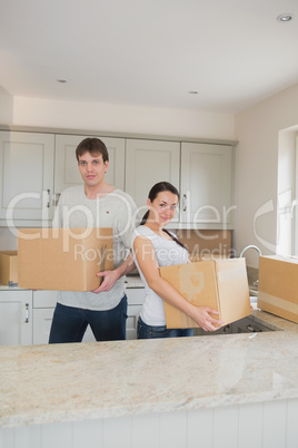 Two people standing in the kitchen