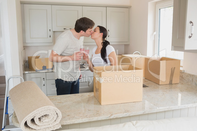 Happy couple kissing in the kitchen