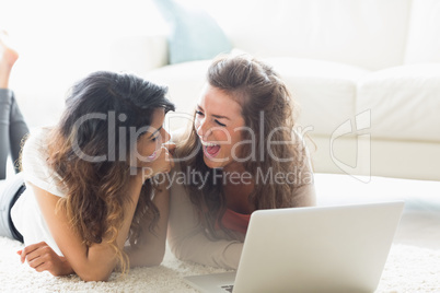 Two laughing women with a computer