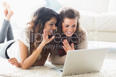 Two women using video chat on laptop