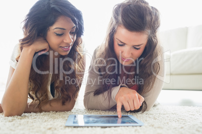 Two women discovering a tablet computer