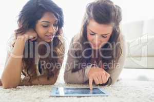 Two women discovering a tablet computer