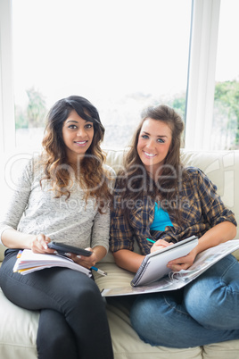 Two happy girls with their homework