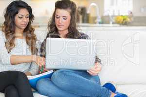 Two girls looking at laptop