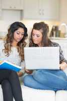 Girls doing homework with laptop