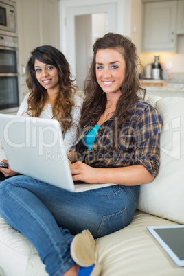 Two happy girls with laptop