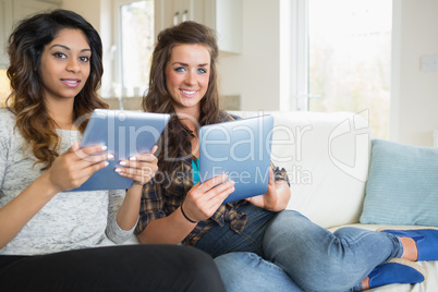 Smiling women with their tablet computers