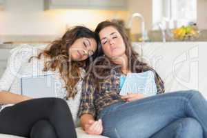Two women napping on couch