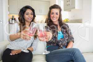 Two girls clinking glasses of champagne