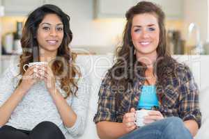 Two women holding cups of coffee