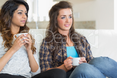 Two girls holding cups of coffee