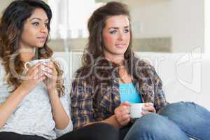 Two girls holding cups of coffee