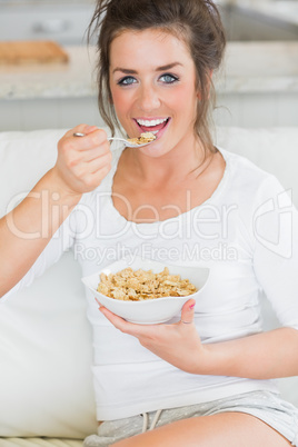 Happy girl eating cereal