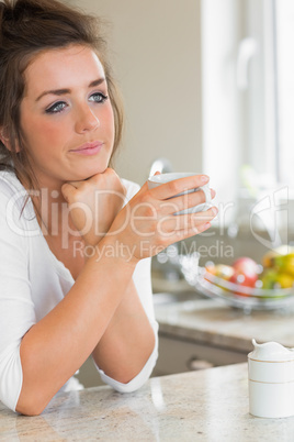 Thinking woman having coffee