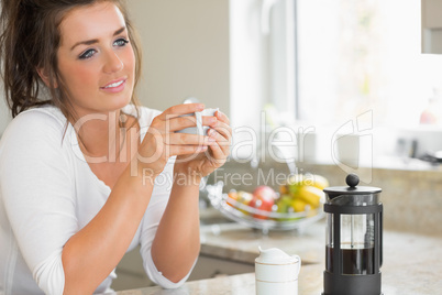 Woman thinking over coffee at breakfast