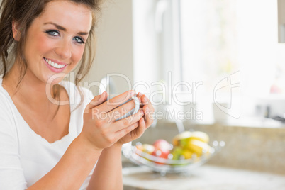 Smiling woman holding coffee cup