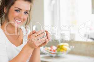 Smiling woman holding coffee cup