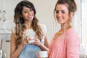 Happy women holding coffee cups