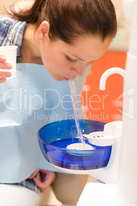 Dental patient woman spit water after treatment