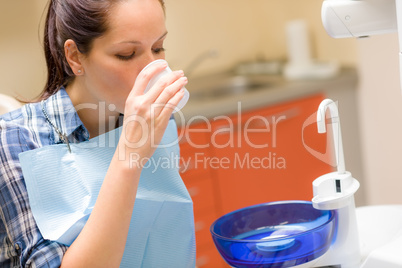 Dental patient woman wash mouth after treatment