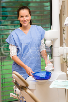 Female dentist assistant at dental surgery smiling