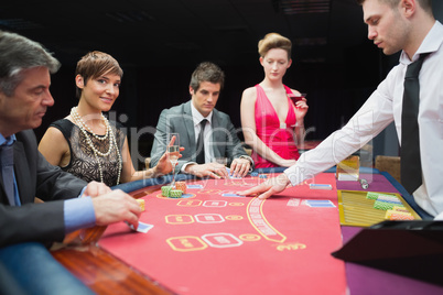 Woman looking up from poker game and smiling