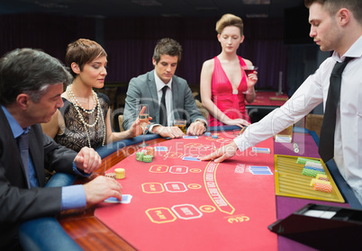 Four people playing poker