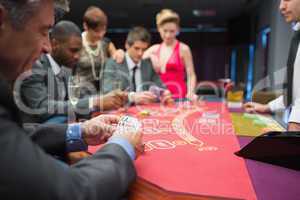 Man looking happily at his poker hand