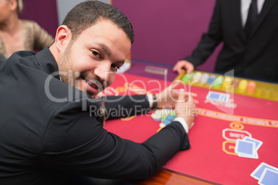 Man looking up from claiming his winnings