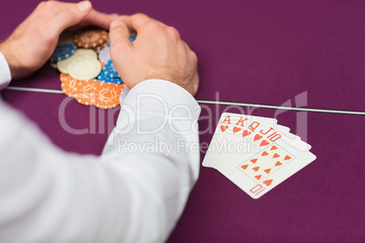 Man winning at poker with royal flush