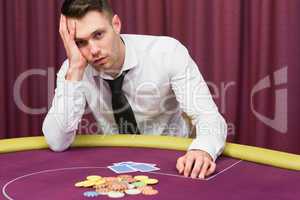 Man looking worried at poker table