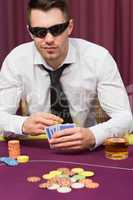 Man in sunglasses playing poker