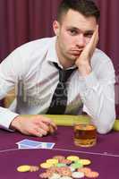 Man looking depressed at poker table