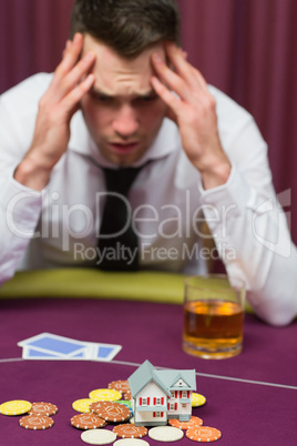 Man betting his house at poker game
