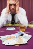 Man betting cash at poker game
