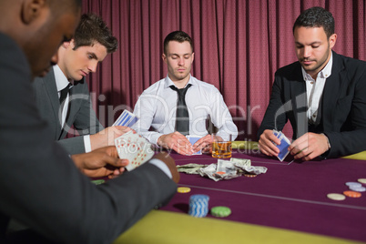 Men playing high stakes poker game