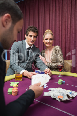 Happy couple playing poker