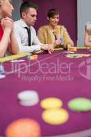 Woman placing bet at poker game