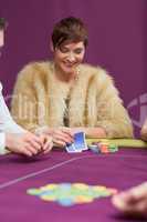 Woman smiling looking at her cards