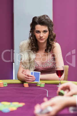 Woman sitting holding cards