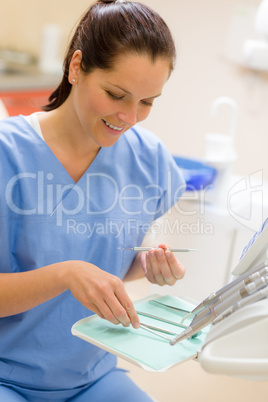 Female dentist with dental equipment at surgery