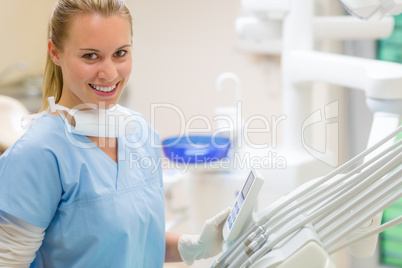 Female dentist with dental equipment at surgery