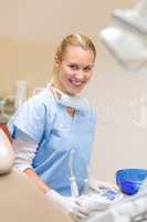 Smiling dental practitioner prepare medical tools