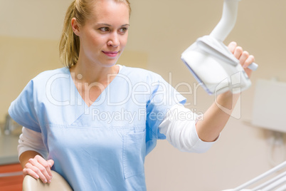 Dental assistant prepare chair for patient